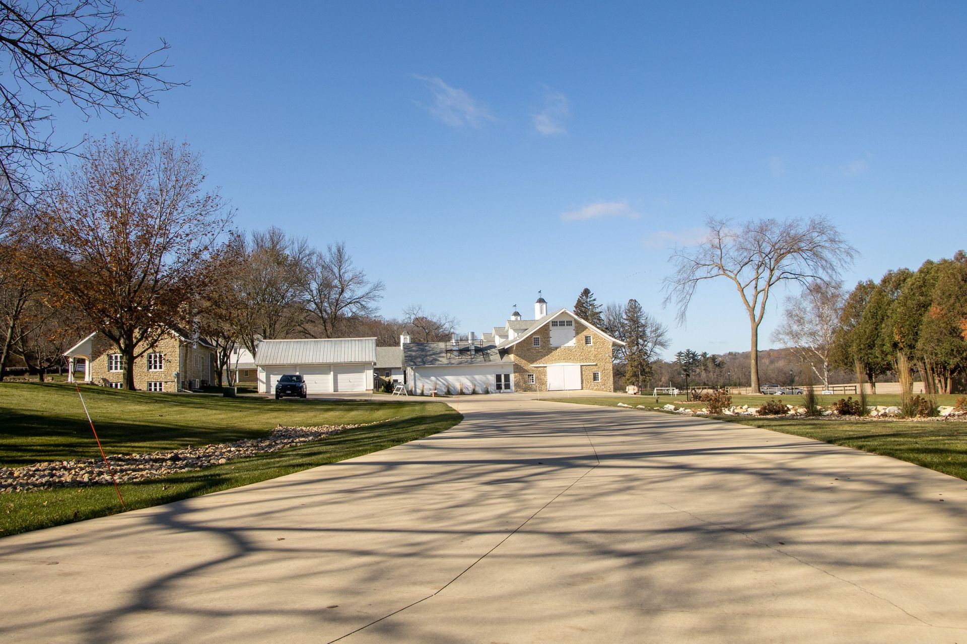 Charming rural estate with a long driveway in Rochester, MN, captured on a sunny day.